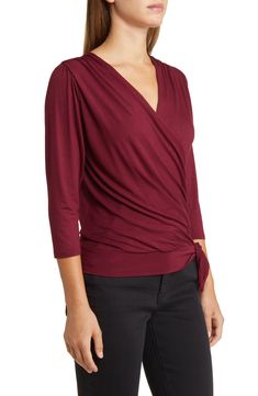 Cut from a soft, drapey jersey knit with an easy faux-wrap design, this top is an ideal choice for both casual looks or more styled up outfits. 23" length Surplice V-neck Three-quarter sleeves 95% rayon, 5% spandex Machine wash, dry flat Imported Solid Color V-neck Faux Wrap Top, Chic Solid Surplice Neckline Tops, Chic Surplice Neckline Tops, Stretch V-neck Top With Twist Front, Versatile Stretch Wrap Top, Stretch V-neck Twist Front Top, Stretch Twist Front V-neck Top, Chic Wrap Tops For Loungewear, Long Sleeve Faux Wrap Top For Work