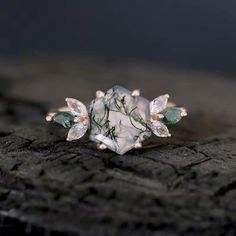 a white and green ring sitting on top of a piece of wood