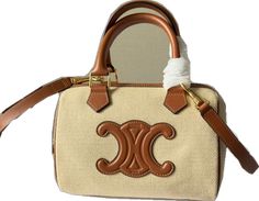 Designer Medium Shopping Bag, Designer Medium Bags For Daily Use, Designer Tan Top Handle Bag, High-end Bags With Leather Top Handle, High-end Top Handle Bag With Leather Handles, Designer Satchel For Shopping, Designer Medium Satchel For Shopping, Designer Medium Bags For Everyday Use, Designer Tan Bag