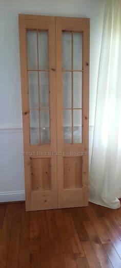 an empty room with wooden floors and two glass doors on the front side of the door