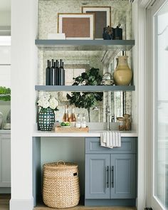 the shelves in this kitchen are filled with vases and other decorative items on them