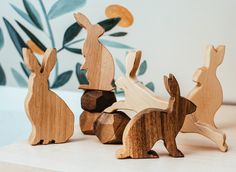 four wooden rabbits sitting next to each other