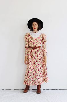 This is a sweet bib-front floral dress, with a boho western vibe and lightweight maxi skirt. No tags- handmade with quality. Metal zipper back closure. Skirt and shoulders have a small crinoline lining for shape, can be removed should you choose. Measures: Across Shoulders: 15”Bust: 36”Waist: 28”Hips: 40”Sleeve: 24”Length: 52”Condition: one tiny and faint droplet near shoulder seam, no bigger than a pinprick.FOLLOW US ON INSTAGRAM FOR DEALS AND SNEAK PEEKS! @Wildthingvintageinstagram.com/wildthi Boho Western Dress, Yves Saint Laurent Designer, Lightweight Maxi Skirt, Cowgirl Vintage, Sack Dress, Cottagecore Vintage, Western Dress, Cottagecore Style, Vintage Cowgirl