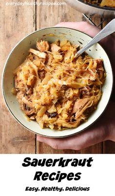 two hands holding a bowl of sauerkraut next to another bowl of food