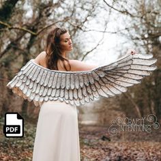 a woman in a white dress holding an angel wing