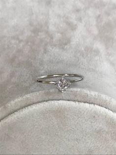 a diamond ring sitting on top of a white blanket