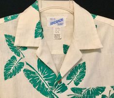 "This is a rare, vintage 1950s-1960s, mens, size medium (Chest 44\"), leaf, print, Hawaiian shirt made for \"Andrade\" Fine Resort Apparel. The fabric is a thick, woven, linen-like, barkcloth material with a content of 50% cotton & 50% polyester. This shirt has a notched-collar, short sleeves, 1 perfectly matched chest pocket, a back yoke with 2 darts, wood buttons and a straight-cut hemline. The white/off white material used in this shirt was made by \"Hawaiian Textiles\" and is haphazardly Vintage White Hawaiian Shirt For Beach, White Retro Hawaiian Shirt For Vacation, Vintage White Camp Shirt For Beach, Vintage Hawaiian Shirt For Vacation, Vintage Hawaiian Shirt With Tropical Print, Vintage White Hawaiian Shirt With Camp Collar, Vintage Camp Shirt With Tropical Print, Vintage White Collared Hawaiian Shirt, Vintage Tropical Print Camp Shirt