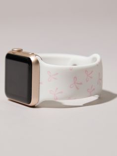 an apple watch with pink and white designs on it's wristband, against a gray background