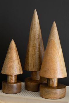 three wooden toy trees sitting on top of a table