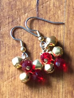 Gold plated tiny jingle bells and bright red Swarovski crystals on surgical steel ear wires. Holiday Red Nickel-free Jewelry, Nickel-free Metal Christmas Jewelry, Festive Red Dangle Crystal Earrings, Red Metal Earrings For Celebration, Bell Earrings, Fruit Necklace, Wooden Flowers, Jingle Bell, Cluster Earrings