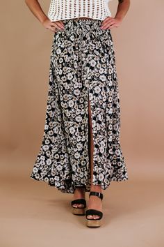 The Floral Smock Waist Tiered Flared Maxi Skirt in Black is a chic and versatile addition to your wardrobe. This skirt features a floral pattern and a smock waist, providing both style and comfort. The tiered and flared design adds a touch of flair, making it a perfect choice. Floral print Woven maxi skirt High waisted Drawstring self-tie Smocked waist Button-front closure Front slit Tiered flared skirt Ankle length Relaxed fit. Fabric Contents: 100% Polyester Imported Model Specs: Emily is wearing a size small in the photo.How will this item fit you? Check out our MODEL SPECS (Typical Sizing - Karli: S-Size 5/26 - 5ft 2in, Emily: S-Size 3/25 - 5ft 5in, Syd: L/XL- Size 15/ - 5ft 8in) Measurements: (Approximate. Measured Laying flat. *Super stretchable waistband offers versatile sizing. ) S Maxi Skirt High Waisted, Flare Maxi Skirt, High Waisted Maxi Skirt, Everyday Chic, Flared Skirt, Chic Boutique, Skirt Black, Black Media, Flare Skirt