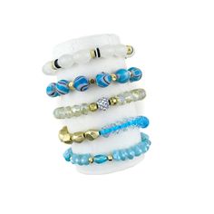 * Unlock the island-y vibe with this chic stack of five white and blue stretch bracelets! Live life at your own pace and enjoy complete beach-day relaxation. With Living on Island Time, you'll be saying "Aloha, stress!" in no time. * All Stretch and All Separate pieces. * Bracelets are 'one size fits most' and are designed to fit wrists up to 7.5" comfortably. * Lead & Nickel Free * Please be aware that due to the unique and handmade nature of each product, colors, shapes, and bead sizes may var Multicolor Stackable Bracelets For Beach, Beach-ready Green Stackable Jewelry, Turquoise Ocean-inspired Bracelets For Vacation, Beach-ready Polished Multicolor Beaded Bracelets, Turquoise Multi-strand Bohemian Beads, At Your Own Pace, Your Own Pace, Bead Sizes, No Time