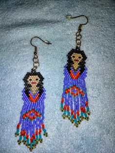 Hand beaded using Miyuki Delica beads and nylon thread. Native american style. Colorful Native American girls. The primary color of these is purple but I can make them in other colors, just ask. All my earrings are make with great care, I take pride in my work. I do all the beading myself and its all double sewn when possible for added strength. Hypoallergenic Purple Beaded Earrings, Adjustable Hypoallergenic Purple Beaded Earrings, Traditional Handmade Purple Beaded Earrings, Handmade Traditional Purple Beaded Earrings, Purple Adjustable Earrings With Tiny Beads, Adjustable Purple Earrings With Tiny Beads, Traditional Purple Beaded Earrings, Traditional Purple Earrings With Colorful Beads, Adjustable Purple Beaded Earrings With Colorful Beads