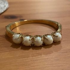 Gold-Tone Polished Band With Faux Pearl Inlay Bracelet. Secured Clasp. Hinge Opening. Bangle Style. Never Worn Excellent Condition, Very Minor Surface Tarnish From Time. Chic Kate Spade Bangle Bracelet, Party Bracelets With Hinged Detail, Kate Spade Bangle Bracelet For Formal Occasions, Kate Spade Bangle For Party, Kate Spade Formal Bangle Bracelets, Kate Spade Formal Bangle Bracelet, Kate Spade Party Bangle Jewelry, Kate Spade Party Bangle, Kate Spade Bangle Bracelets For Party