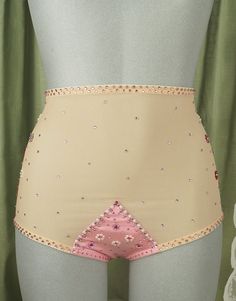 a woman's panties with beading on the bottom and pink underbusk