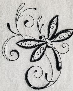 an embroidered dragonfly on a white towel