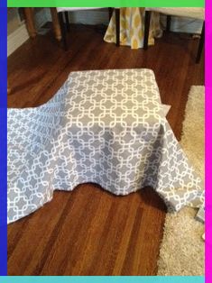 an image of a table cloth on the floor in front of a chair and rug