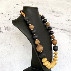 This unique bohemian necklace was hand beaded using a modern mix of large 25mm round mustard yellow wooden rondelles, distressed 28mm and 18mm round wood beads in black and muted brown, a variety of small beige wooden beads, tiny black lava stone rondelles, and black and white agate gemstones.  The necklace measures 31 inches in length and is fastened with a sterling silver toggle clasp.  A unisex necklace that is perfect for any gender!  I guarantee that no one else on the planet will have THIS Bohemian Beaded Necklaces With Large Beads For Everyday, Everyday Bohemian Necklace With Wooden Beads, Unique Everyday Beaded Necklaces, Bohemian Necklaces With Large Beads For Everyday, Bohemian Necklace With Large Beads For Everyday, Bohemian Everyday Necklace With Large Beads, Artisan Round Bead Necklaces For Everyday, Artisan Necklace With Brown And Black Beads, Artisan Necklace With Round Beads For Everyday