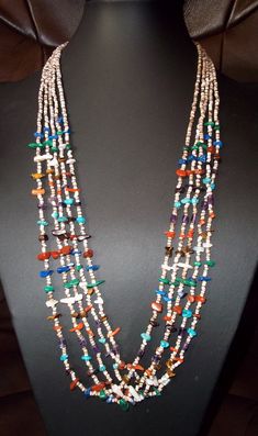 This is a beautiful  Heishi necklace made from some of the best know semi-precious stones used in Native American jewelry. There are five strands of shell Heishi with the stones strung so well that it looks like stripes of red, green, blue, yellow, purple and white have been painted on horizontally. The stone used are Turquoise, Malachite green, Amethyst, Lapis Lazuli, Coral, Pipestone, Cats-eye, & Mother of Pearl. I think that got them all. The necklace is approx. 26" overall length and weighs Southwestern Multi-strand Polished Bead Necklaces, White Multi-strand Jewelry With Natural Stones, Hand-strung White Multi-strand Necklace, White Multi-strand Hand-strung Jewelry, Southwestern Multi-strand Gemstone Bead Necklaces, Southwestern Multi-strand Gemstone Beads Necklace, Southwestern Multi-strand Necklace With Gemstone Beads, Multicolor Multi-strand Necklaces With Natural Stones, Multicolor Multi-strand Necklace With Natural Stones