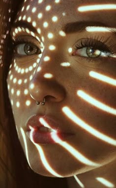 a woman's face with light shining through it