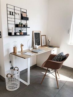 a desk with a chair, lamp and pictures on the wall