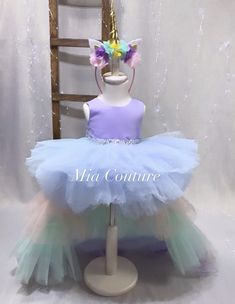 This beautiful handmade multi color ; Sky Blue Lavender ; Pink ; Green ; unicorn style tulle layered princess gown ( Hair Bow Included ) can be customized to the colors of your liking ; please feel free to contact us directly for inquiries & customization orders . Thank You ! Cute Purple Tulle Tutu Dress, Purple Princess Pageant Dress In Tulle, Purple Princess Tulle Pageant Dress, Purple Princess Pageant Dress With Tulle, Cute Tutu Dress With Unicorn Print For Party, Cute Unicorn Print Tutu Dress For Party, Princess Tutu Dress With Unicorn Print For Dress-up, Princess Tulle Pageant Dress For First Birthday, Cute Purple Tulle Fairy Dress