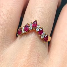 "A vintage ruby and diamond band or stacking ring. There are five fierce red-pink cut rubies alternating with bright brilliant cut diamonds. The inside of the ring is stamped \"18K\" and \"750\" for gold purity. Approximate Carat Weight of Rubies: 0.60 Carats Approximate Carat Weight of Diamond: 0.16 Carats Ring Size: 6.5 (Resizable) Gold Purity: 18K Gold Weight: 3.6 Grams Markings: \"18K\" \"750\"" Red Ruby Ring With Marquise Cut Diamond, Red Ruby Ring With Vvs Clarity And Baguette Cut, Red Diamond Ring With Rose Cut Lab-created Ruby, Red Baguette Cut Diamond Accent Rings, Red Baguette Cut Ruby Ring, Red Marquise Rings With Rose Cut Diamonds, Red Marquise Rose Cut Diamond Rings, Baguette Cut Ruby Ring For Anniversary, Red Baguette Cut Lab-created Ruby Ring