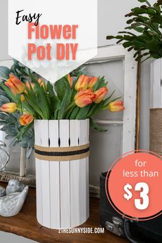 a white vase filled with flowers on top of a table