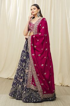 Purple lehenga embroidered with aari in a floral pattern all-over. Comes with pink embroidered half sleeve blouse and scallop border dupatta.
Components:3
Pattern:Embroidery
Type of Work:Aari
Neckline:Leaf
Sleeve Type:Half
Fabric:Silk and Raw Silk
Color:Purple,Pink
Other Details:
Embroidered dupatta with scallop border
Low back with tie up and tassels
Lehenga with side tie up
Blouse with curved hem
Occasion:Bride - Aza Fashions Embroidered Banarasi Silk Choli For Navratri, Diwali Embroidered Semi-stitched Lehenga, Embroidered Semi-stitched Choli With Traditional Drape, Festive Embroidered Lehenga In Chinon, Eid Choli With Intricate Embroidery In Chinon, Festive Embroidered Chinon Lehenga, Eid Chinon Choli With Intricate Embroidery, Dola Silk Sharara With Resham Embroidery For Reception, Embroidered Floor-length Lehenga For Eid