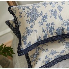 two blue and white pillows sitting next to each other