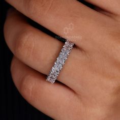 a woman's hand with a diamond ring on it