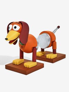 a toy dog that is on top of a wooden stand with a guitar in it's mouth