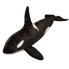 an orca whale stuffed animal on a white background