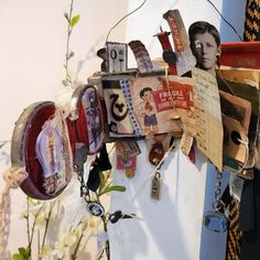 there are many different items hanging on the wall and one is made out of newspaper