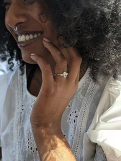 a close up of a person talking on a cell phone with an afro hairstyle