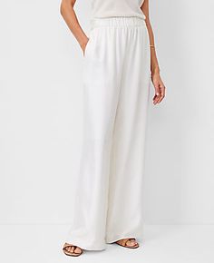 Elevate your wardrobe with the Ann Taylor Studio Collection Easy Palazzo Pants, a blend of luxury and comfort. These pants are a fashion-forward choice with their wide-leg design and high-rise fit, perfect for making a sophisticated statement.

- Size: Large
- Color: Winter White
- Material: Shell 100% Silk, Lining 100% Polyester
- Fit: Relaxed and easy
- Length: Full length, 31" inseam with a 27" leg opening
- Features: Elasticized waistband, vertical on-seam pockets, lined
- Care: Machine wash Elegant Tapered Leg Loungewear Bottoms, Elegant Tapered Leg Pants For Loungewear, Elegant Pants With Elastic Waistband For Daywear, Elegant Tapered Leg Pants With Elastic Waistband, Elegant Pants With Elastic Waistband And Tapered Leg, Elegant Bottoms With Elastic Waistband And Relaxed Fit, Elegant Stretch Pants For Daywear, Elegant Tapered Leg Bottoms With Elastic Waistband, Elegant White Wide Leg Pants With Elastic Waistband