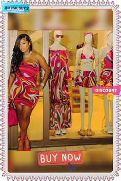 a woman standing in front of a store window with mannequins behind her