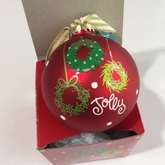 an ornament in a box with the word sold on it