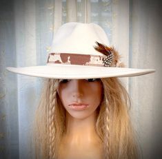 #14 in Rodeochics custom Hats White 2x wool hat is beautiful adorned with new Cowhide Hatband Hatband fabric is faux hide. A beautiful grouping of wild feathers accent the side Hook n loop closure Hat has a drawstring for making a smaller fit if needed Adjustable Cream Hat Bands For Fall, Adjustable Cream Felt Hat For Country Events, Adjustable Feather Hat Bands For Fall, Adjustable Cream Hat For Fall, Festival Flat Brim Hat With Feather Trim, Cream Brimmed Felt Hat For Country Events, Adjustable White Hat Band For Fall, Adjustable Hat Band With Feather Trim And Flat Brim, Country Style Cream Felt Hat With Short Brim