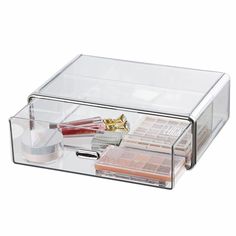 an acrylic box with cosmetics and makeup products in it on a white background