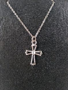 This unique silver tone Cross pendant hangs on an 18 inch stainless steel chain. Affordable yet stylish, this pendant is a must-have accessory.  Costume jewelry is a versatile, affordable, low risk accessory that complements any outfit. Details: Height = 20mm Width  = 16mm 18" (inch) Stainless Steel Chain *Item has slight wear from use. Steel Chain, Stainless Steel Chain, Outfit Details, Cross Pendant, Pendant Necklaces, Costume Jewelry, Halloween Shopping, Jewelry Necklace Pendant, Beauty Book