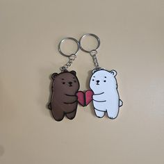 two key chains that are shaped like bears