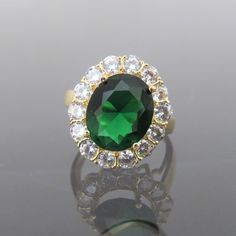 Vintage 18K Solid Yellow Gold Emerald & White Topaz Halo Ring ...Marked 18K...Total of weights 4.2grams...Size 7Measure of Face 18.2MM...It's in very good condition. #501836 Elegant Gold Gemstones With Center Stone, Gold Emerald Cluster Ring With Brilliant Cut, Gold Oval Gemstones With Brilliant Cut, Gold Emerald Cluster Ring With Halo Setting, Gold Jewelry With Halo Setting For May Birthstone, Gold Emerald Cluster Ring Hallmarked, Gold Crystal Ring For Formal Occasions In May, Luxury Gold Diamond Ring For May Birthstone, Formal Gold Emerald Crystal Ring