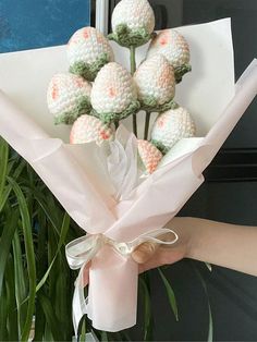 a bouquet of crocheted flowers in front of a door