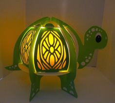 a green turtle lamp sitting on top of a table