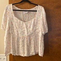 Size Xl, Cream With Little Orange-Ish Flowers. Elastic On Sleeves. New Without Tags! White Ditsy Floral Print Summer Top, White Ditsy Floral Print Top For Summer, White Ditsy Floral Print Short Sleeve Top, White Cotton Blouse With Ditsy Floral Print, Summer Cotton Tops With Ditsy Floral Print, White Cotton Top With Ditsy Floral Print, Orange Short Sleeve Blouse For Spring, Casual Flowy Blouse With Ditsy Floral Print, Feminine Ditsy Floral Print Tops For Daywear