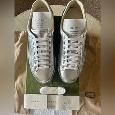 This Is A Pair Of Authentic Silver Metallic Leather Gucci Sneakers New In Box Men’s Size 7 Or Women’s Size 9.5/10 New In Box Thanks For Stopping By! Designer Gucci Sneakers With Embossed Logo, Luxury Gucci Sneakers, Classic Gucci Sneakers With Embossed Logo, Classic Gucci Sneakers, Gucci Designer Calf Leather Sneakers, Gucci Designer Sneakers For Formal Occasions, Gucci Designer Formal Sneakers, Gucci Ace Sneakers, Gucci Shoes Sneakers