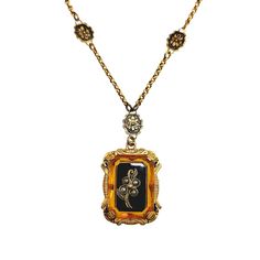 Behold this splendid Victorian revival necklace from the 1930s, adorned with orange and black glass elegantly encased in brass. The floral design exudes a delicate and distinctly feminine charm, a prevailing characteristic of its time. The tiny imitation seed pearls add charm, and the back is engraved with the monogram MLM. The necklace is in very good vintage condition with minimal signs of wear. The glass's surface shows fine lines but nothing distracting. The brass chain is not damaged, and t Vintage Black Enamel Necklace For Evening, Vintage Black Enamel Necklaces For Evening, Vintage Black Enamel Rectangular Jewelry, Orange Victorian Jewelry For Formal Occasions, Vintage Rectangular Black Enamel Jewelry, Vintage Black Enamel Jewelry For Formal Occasions, Vintage Black Jewelry With Antique Finish, Vintage Black Enamel Necklace For Formal Occasions, Vintage Black Enamel Necklaces For Formal Occasions