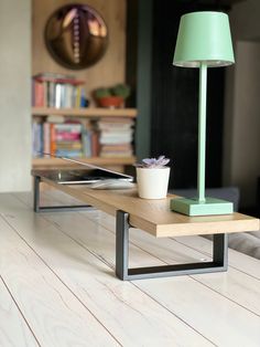 a table with a lamp and a tablet on it