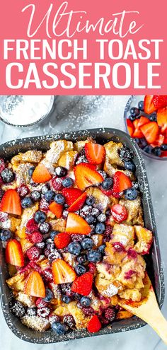 french toast casserole with berries and powdered sugar on top in a pan